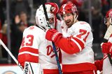 Dylan Larkin slaví výhru nad Buffalo Sabres s brankářem Petrem Mrázkem