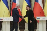 Český prezident Petr Pavel a ukrajinský prezident Volodymyr Zelenskyj si podávají ruce po společné tiskové konferenci uprostřed ruského útoku na Ukrajinu v Kyjevě 21. března 2025