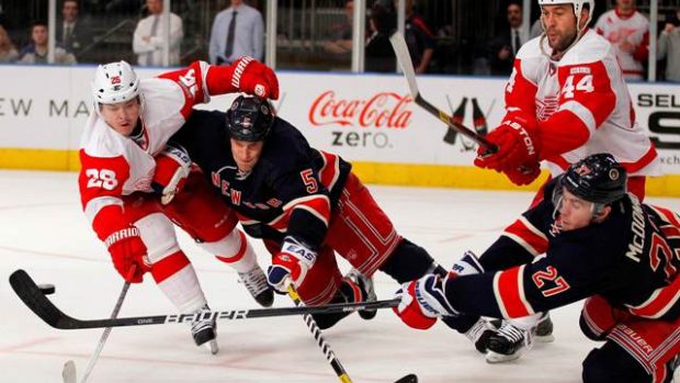 Detroit Red Wings left wing Jiri Hudler (L) and right wing Todd Bertuzzi (2nd R), and New York Rangers defensemen Dan Girardi (2nd L) and Ryan McDonagh battle for the puck in third period action during their NHL hockey game