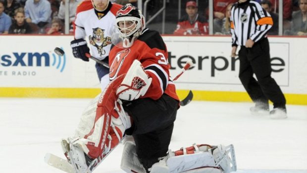 New Jersey Devils goaltender Martin Brodeur  makes a save as Florida Panthers Tomas Fleischmann looks on during the second period of Game 4 of their NHL Eastern Conference quarter final playoff hockey game