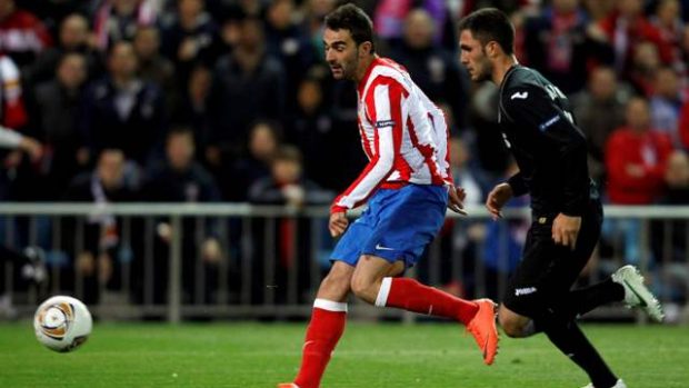 Atletico Madrid&#039;s Adrian Lopez (L) scores past Valencia&#039;s Victor Ruiz during their Europa League  semi-final first leg soccer match against Valencia