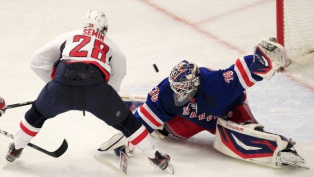 New York Rangers goalie Henrik Lundqvist  (R) makes a save on Washington Capitals&#039; Alexander Semin during the second period in Game 7 of their NHL Eastern Conference semi-final playoff hockey game at Madison Square Garden in New York May 12, 2012