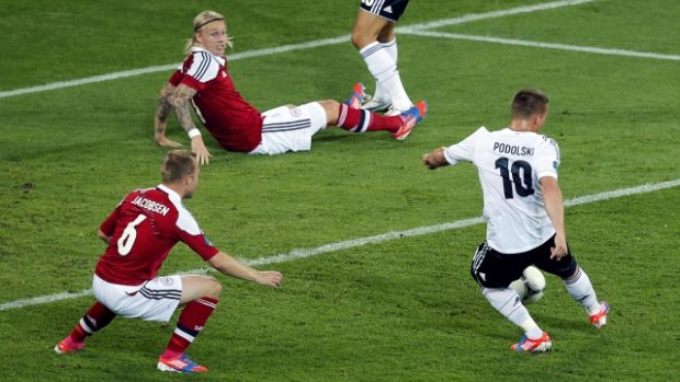 Germany&#039;s Lukas Podolski scores the opening goal during the Euro 2012 soccer championship Group B match between Denmark and Germany in Lviv, Ukraine, Sunday, June 17, 2012. (AP Photo/Michael Probst)