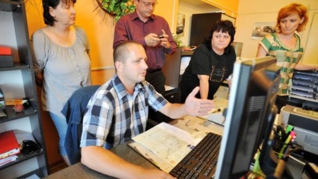 Centrální registr vozidel 11. července stále plně nefungoval. Náměstek ministra dopravy Miroslav Drobný (stojí uprostřed) to přijel vysvětlovat do Pardubic. Na snímku je IT technik ministerstva Petr Očenášek s úřednicemi registru