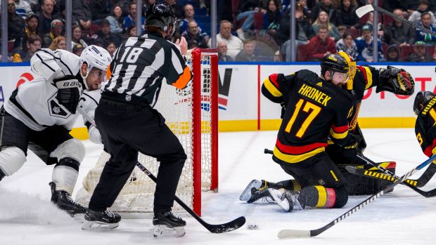 Obránce Vancouveru Canucks Filip Hronek se ohlíží za útočníkem Los Angeles Kings Anžem Kopitarem