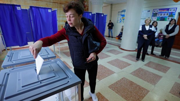Žena vhazuje svůj hlas během světem neuznávaného referenda v Ruskem okupovaném Doněcku