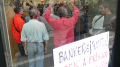 Aktivisté uvnitř bankovní pobočky protestují proti vystěhováním. Krizi podle nich způsobily právě i finanční domy