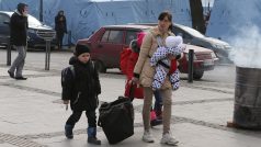 Žena s dětmi na ulici ve Lvově prchající před válkou