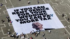 Transparent Greenpeace protestující proti pořádní svatby Jeffa Bezose a Lauren Sánchezové v Benátkách z nápisem: Když si můžete pronajmout Benátky na svou svatbu, můžete platit vyšší daně