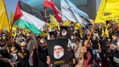 Příznivci Hizballáhu drží fotografie zabitého vůdce Hizballáhu Hasana Nasralláha a palestinské i další vlajky během ceremoniálu u příležitosti prvního výročí Nasralláhovy smrti