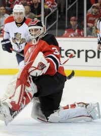 New Jersey Devils goaltender Martin Brodeur  makes a save as Florida Panthers Tomas Fleischmann looks on during the second period of Game 4 of their NHL Eastern Conference quarter final playoff hockey game