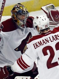 Phoenix Coyotes goalie Mike Smith celebrates defeating the Chicago Blackhawks with teammate Oliver Ekman-Larsson following Game 6 of their NHL Western Conference quarter-final playoff hockey game