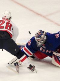 New York Rangers goalie Henrik Lundqvist  (R) makes a save on Washington Capitals&#039; Alexander Semin during the second period in Game 7 of their NHL Eastern Conference semi-final playoff hockey game at Madison Square Garden in New York May 12, 2012