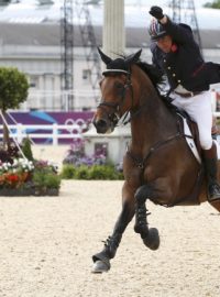 Britain&#039;s Peter Charles  rides Vindicat celebrating his team&#039;s gold medal win during the equestrian team jumping competition in Greenwich Park at the London  2012 Olympic Games August 6, 2012