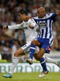 Real Madrid&#039;s Cristiano Ronaldo (L) and Deportivo Coruna&#039;s Manuel Pablo challenge for the ball during their Spanish first division soccer match at Santiago Bernabeu stadium in Madrid September 30, 2012