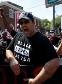 Jeden z demonstrantů s tričkem „Black lives matter“ (doslovně přeloženo Na černých životech záleží)