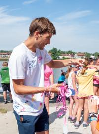 Bývalý moderní pětibojař David Svoboda předává dětem medaile po absolvování Olympijského běhu