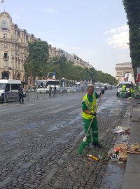 Po večerních oslavách zůstaly na Champs-Élysées tuny odpadků. S košťaty, lopatami a fukary se na ně vrhli uklízeči v zelenožlutých uniformách.